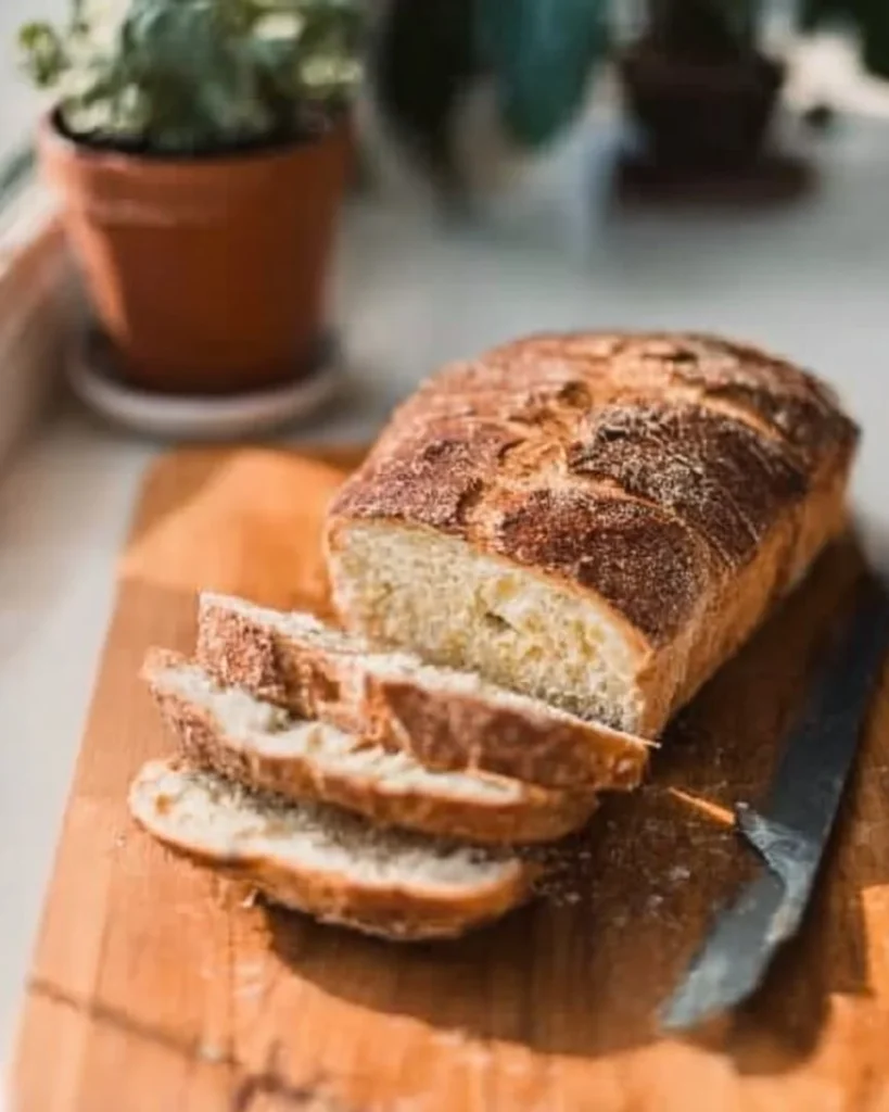 Loaf of gluten-free sourdough bread on a wooden cutting board