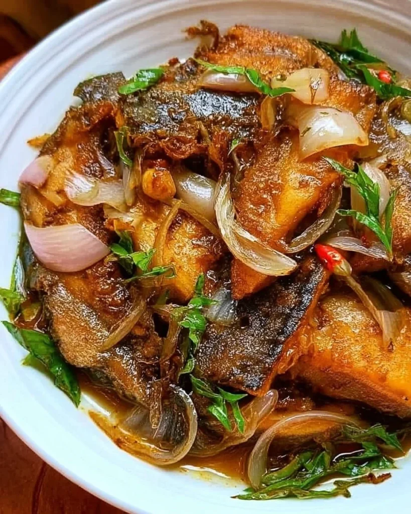 Pan-fried fish seasoned with onion and ginger for a flavorful dish