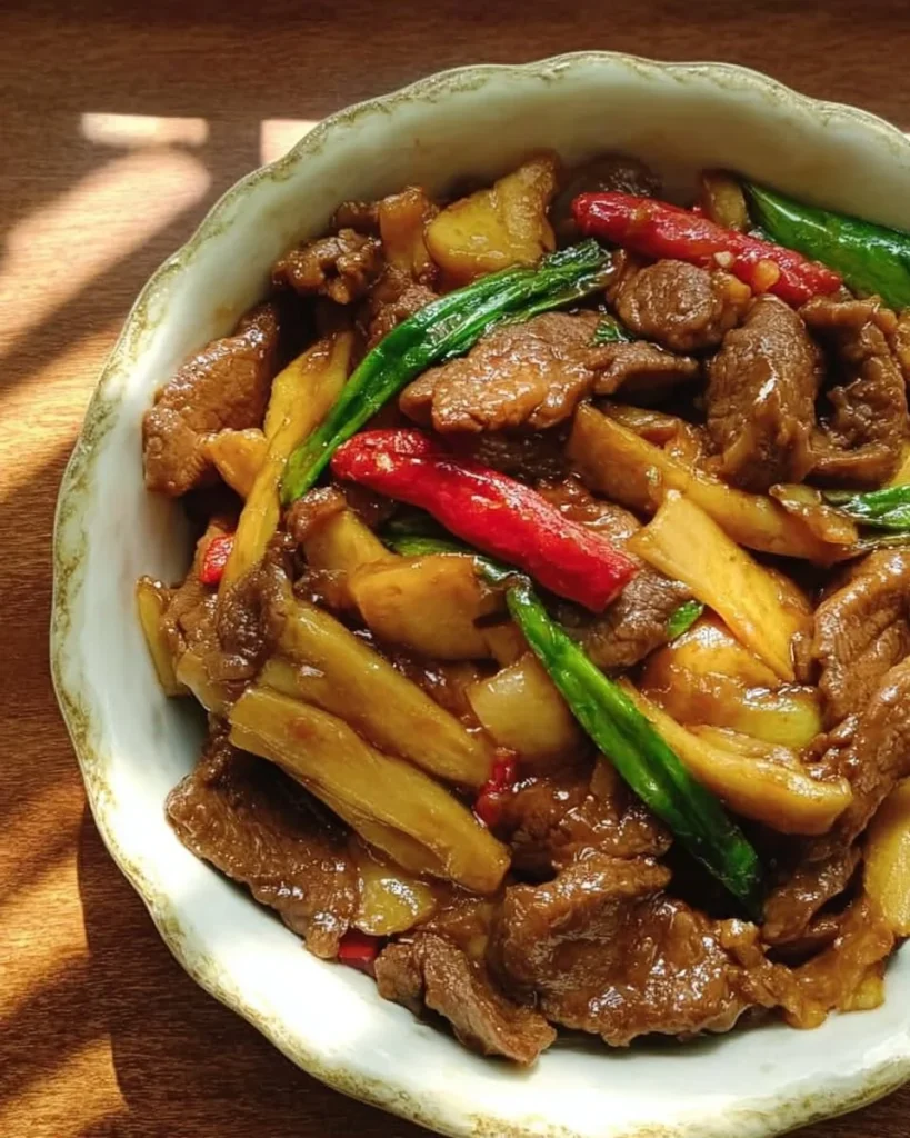 Stir-Fried Beef with Bamboo Shoots and Chili Peppers served in a vibrant dish