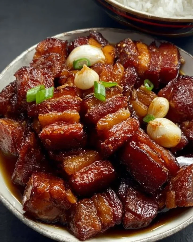 Delicious soy sauce pork belly with garlic, garnished and served on a plate
