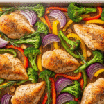 Healthy sheet pan chicken with roasted broccoli and bell peppers, perfect for weight loss meal prep.