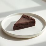 Fudgy chocolate brownie on a white plate, showcasing delicious gluten-free dessert swaps for healthier treats.