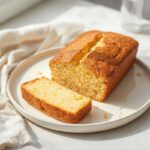 Sliced gluten-free lemon loaf cake with a moist, tender crumb, demonstrating how to fix dry gluten-free baking successfully.