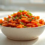 Sweet honey-glazed carrots with fresh parsley in a white bowl, perfect as delicious no-oven holiday sides.